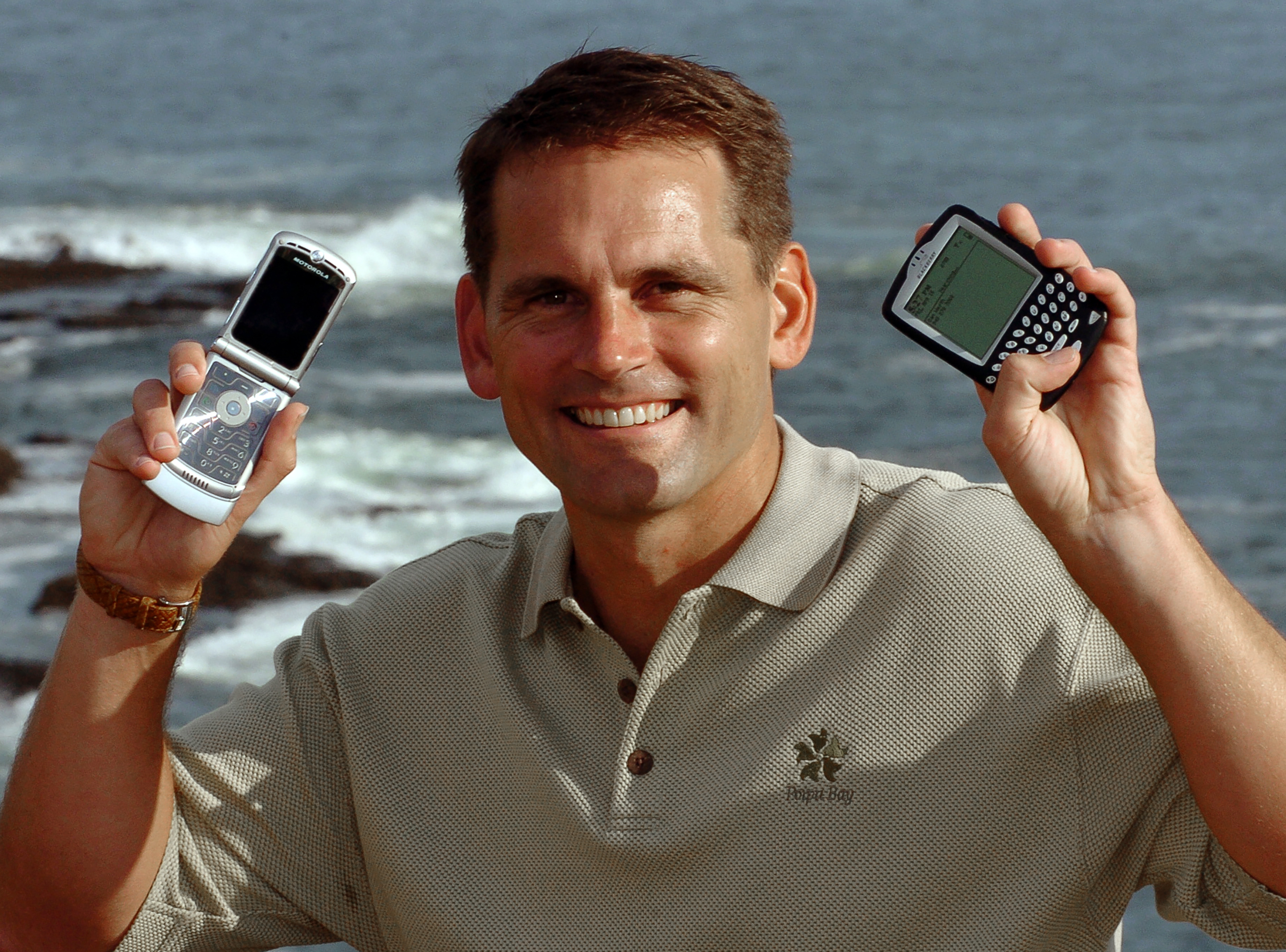 Dan Werth from Irvine, California uses his cellphone and BlackBerry to keep in touch during business travel in remote locations and abroad, April 14, 2005 in Laguna Beach, California. (Photo by Bob Riha, Jr./Getty Images)