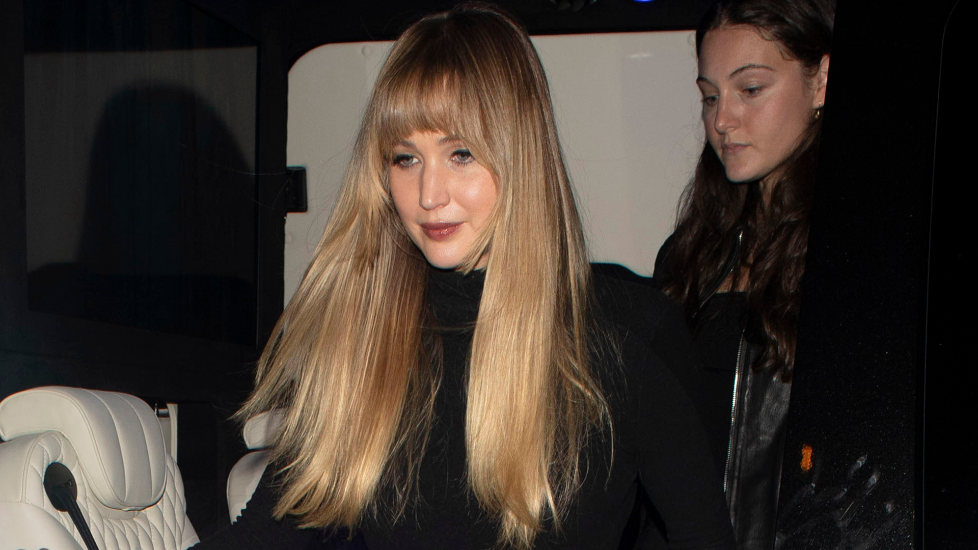 Jennifer Lawrence paired a butter yellow velvet maxi skirt with a matching drawstring bag and a black turtleneck in London