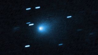 A blue ball of light shines between streaks of blueish light from stars in outer space
