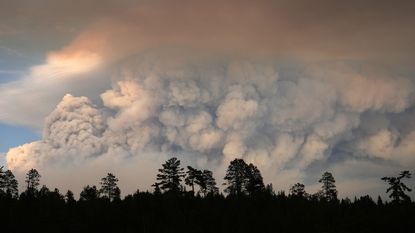 Plumes of smoke rise over Moose Lake as multiple wildfires burn in the Boundary Waters Canoe Area Wilderness in Ely, Minnesota