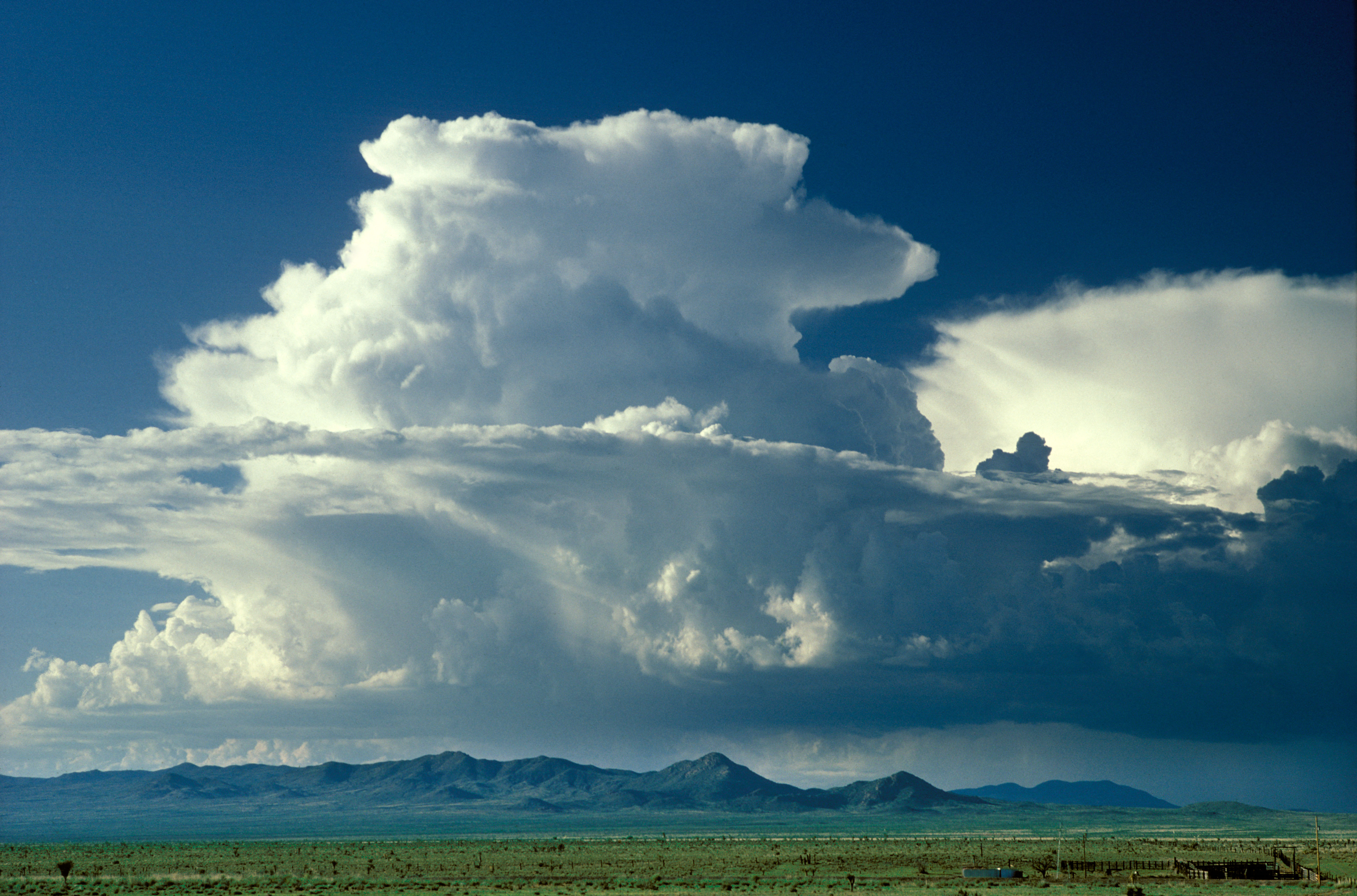 Cumulonimbus capillatus Clouds. Like a giant white anvil on top of a mountain range
