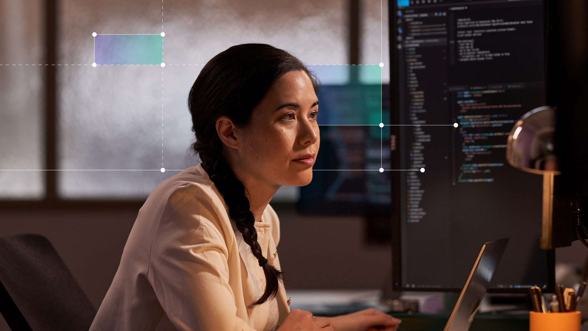 Woman sitting at desk looking at computer screen