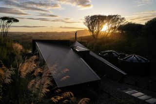 Sloping roof of low-energy New Zealand house at sunset
