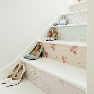 staircase with shoes and white walls