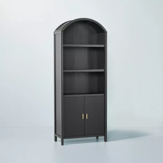 rounded black bookshelf with bottom cabinets