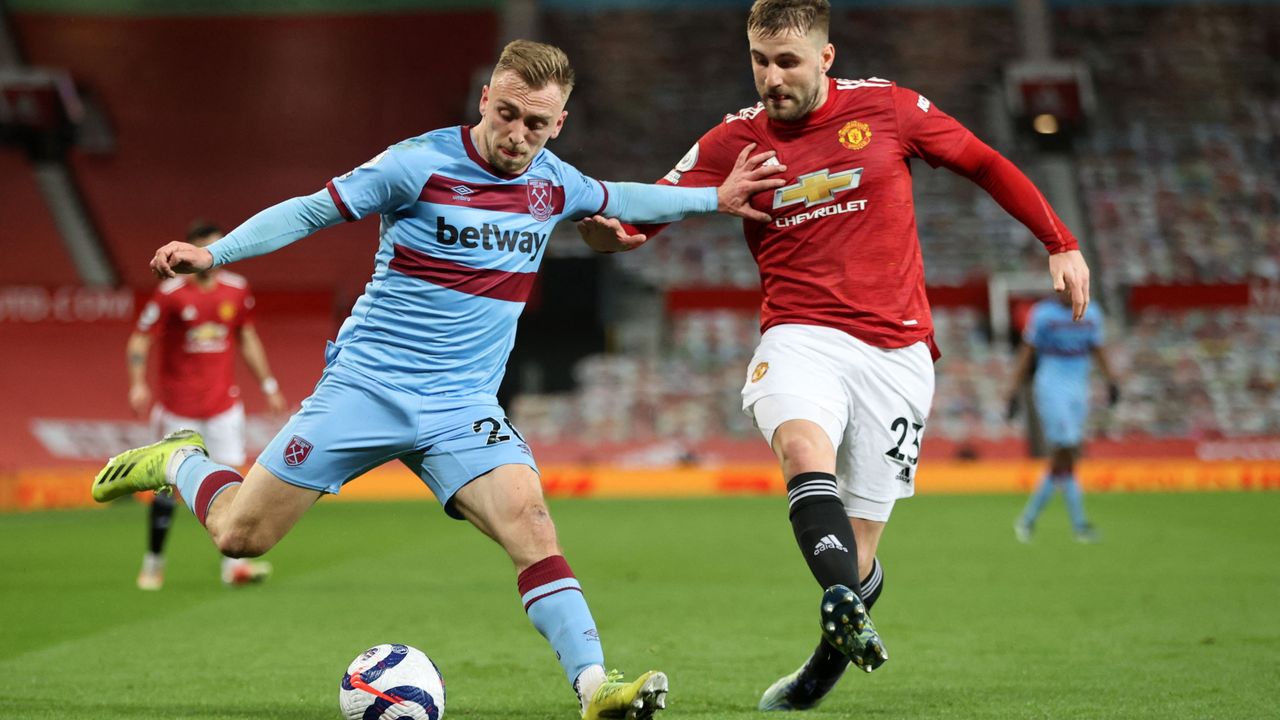 West Ham United&#039;s English striker Jarrod Bowen (L) holds off Manchester United&#039;s English defender Luke Shaw (R) 