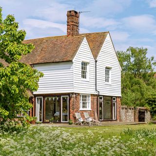 house exterior with gable roof and brick wall