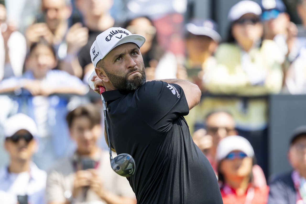 Jon Rahm hits a fairway wood off the tee