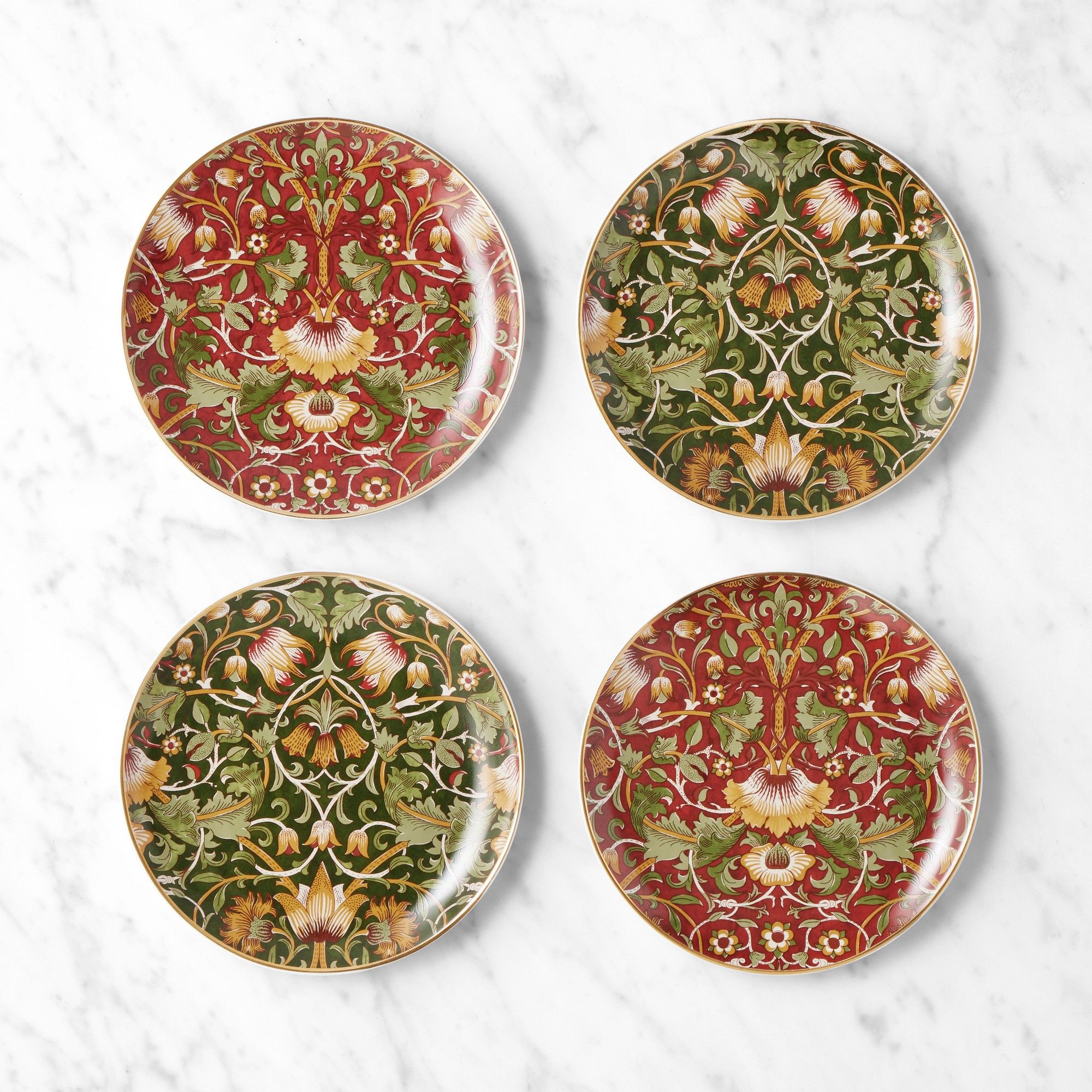 Four appetizer plates with mixed red and green botanical prints
