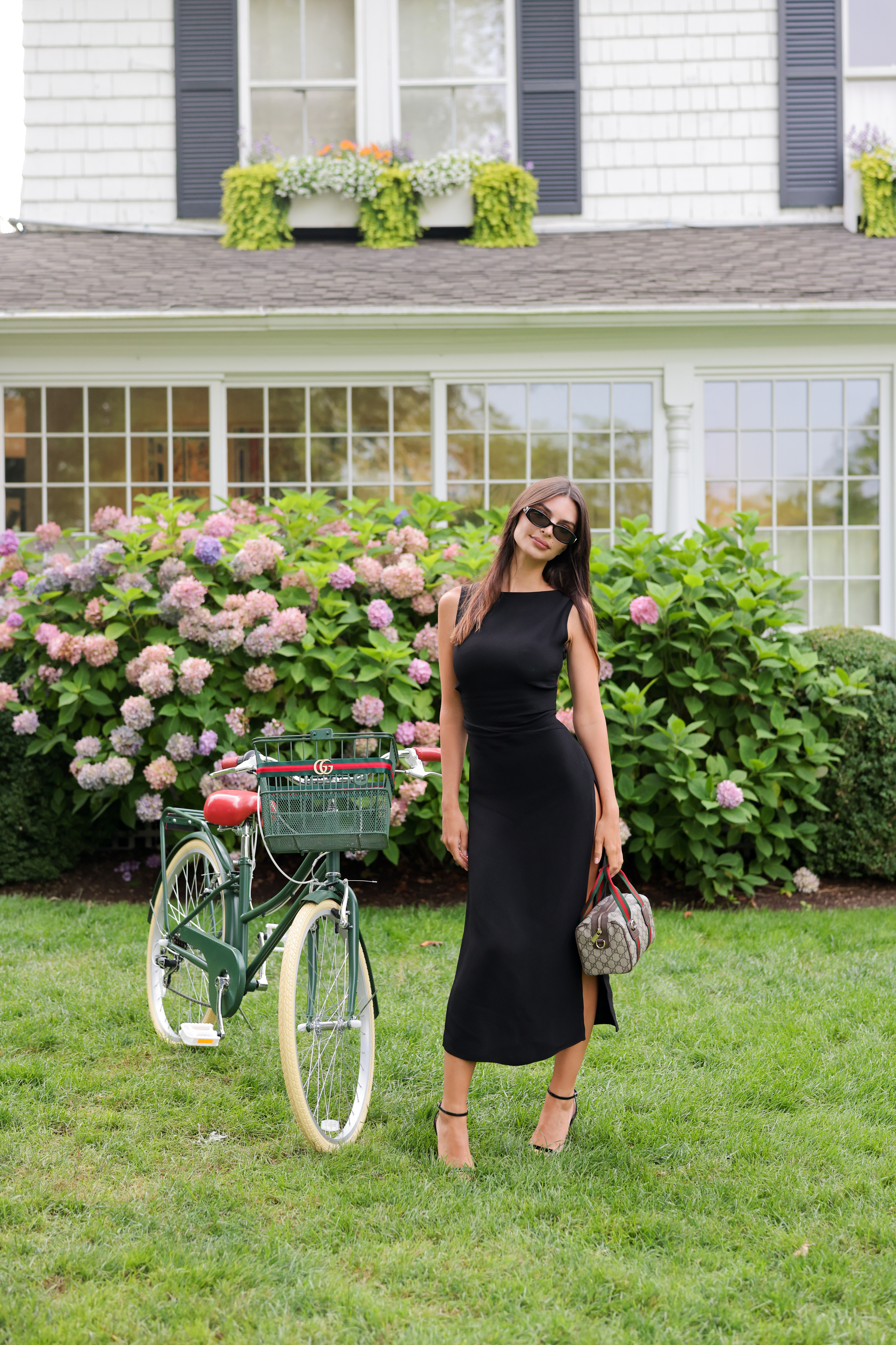Emily Ratajkowski celebrates Gucci's GG monogram campaign in a little black dress with two Gucci Double-G bags