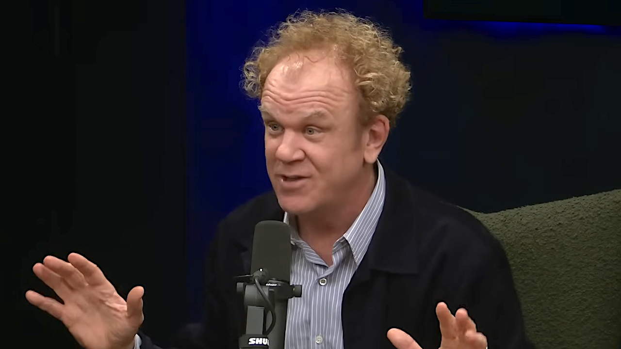 John C. Reilly talking into mic during Ted Danson podcast Where Everybody Knows Your Name