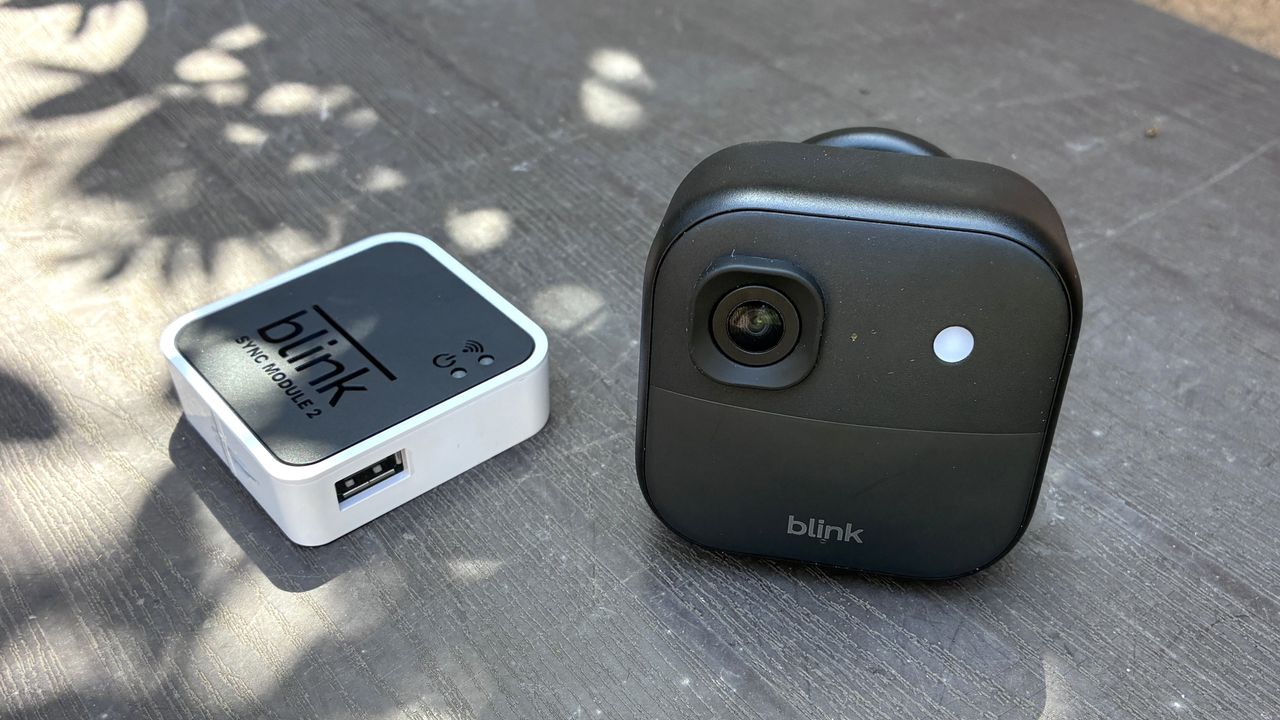 Blink Outdoor 2K+ security camera with hub on table
