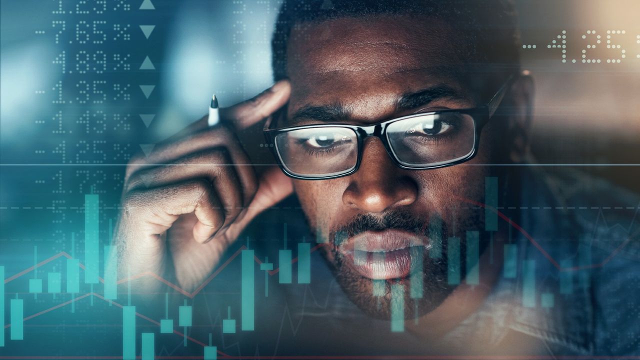 Anxious businessman staring at a graph showing the ups and downs of the stock market