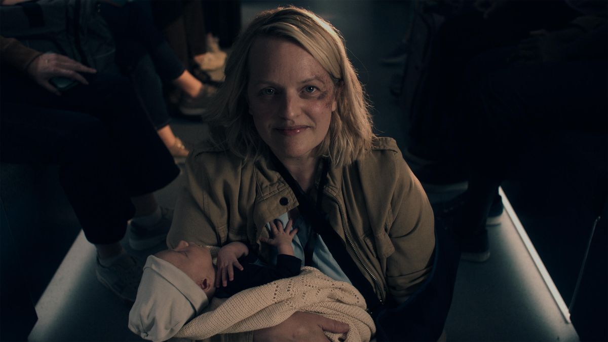 Elizabeth Moss as June holding a baby in The Handmaid&#039;s Tale season 6