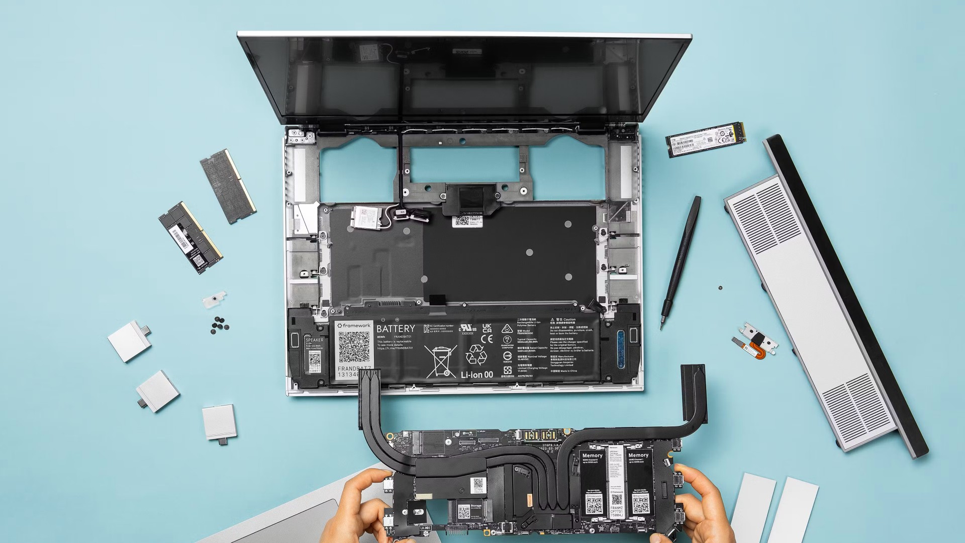 Framework Laptop 16 disassembled on a blue background