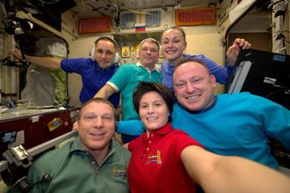 European Space Agency astronaut Samantha Cristoforetti (bottom center) snaps one final group photo of the Expedition 42 crew before they split up on March 11, 2015. NASA astronaut Barry Wilmore (bottom right) and Russian cosmonauts Elena Serova (top right) and Alexander Samokutyaev (top middle) returned to Earth on a Soyuz capsule to wrap up 167 days in space. Cristoforetti, NASA's Terry Virts (bottom left) and Russian Anton Shkaplerov stayed on the station.