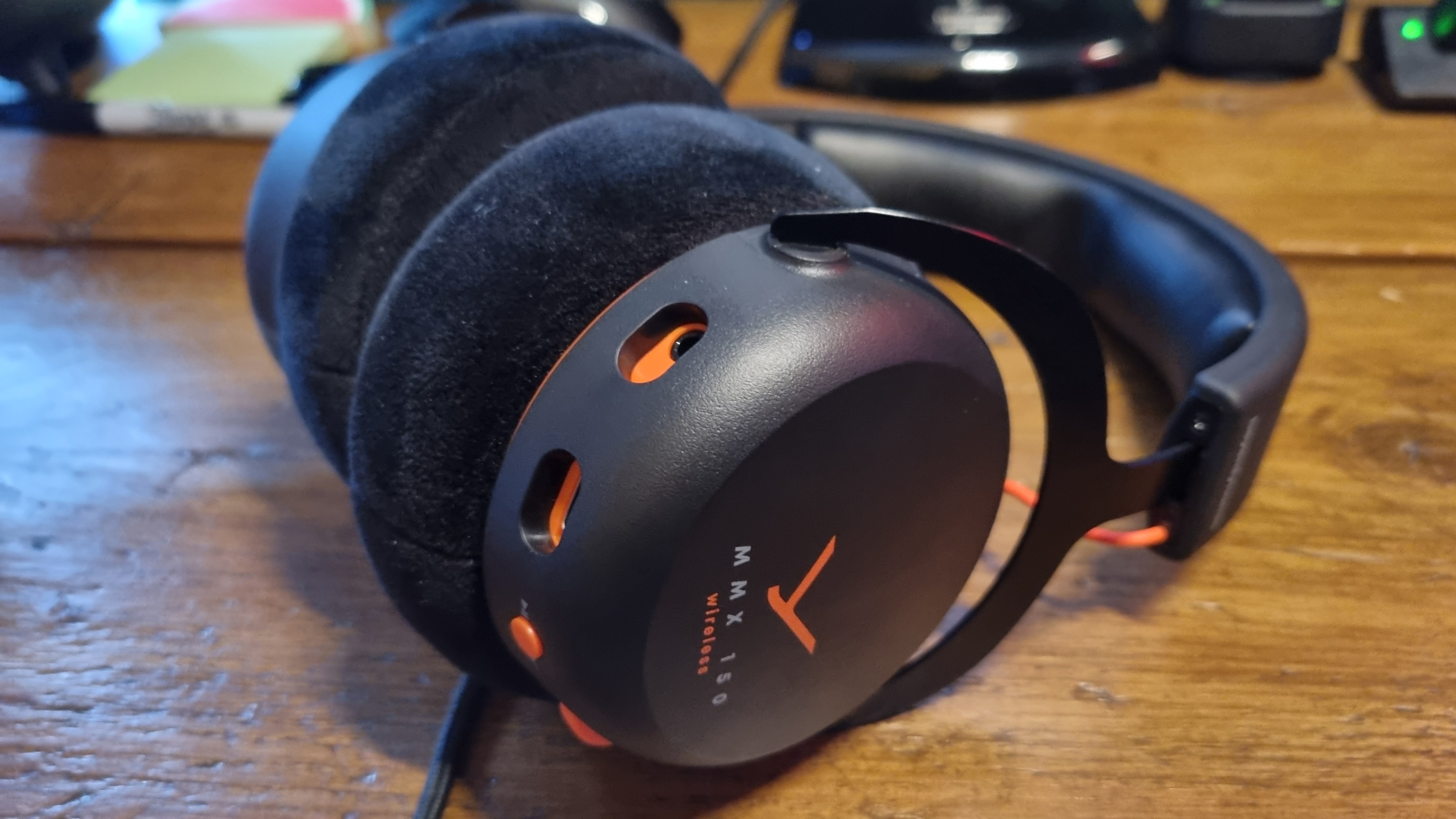 A Beyerdynamic MMX 150 Wireless gaming headset on a wooden desk