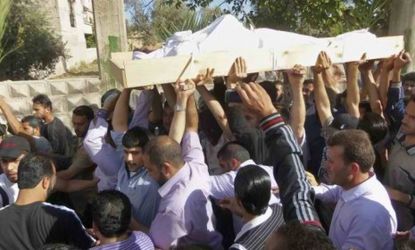 Anti-Syrian regime mourners chant as they carry the body of Khaled Shurbajy during his funeral procession on Saturday: More than 90 people were killed in an attack on the district of Houla.