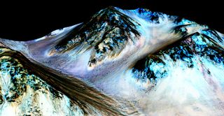 This processed, false-color image of Mars' Hale Crater was taken by the High Resolution Imaging Science Experiment (HiRISE) camera on NASA's Mars Reconnaissance Orbiter. The image highlights dark streaks on the Martian surface known as recurring slope lineae or RSL's.