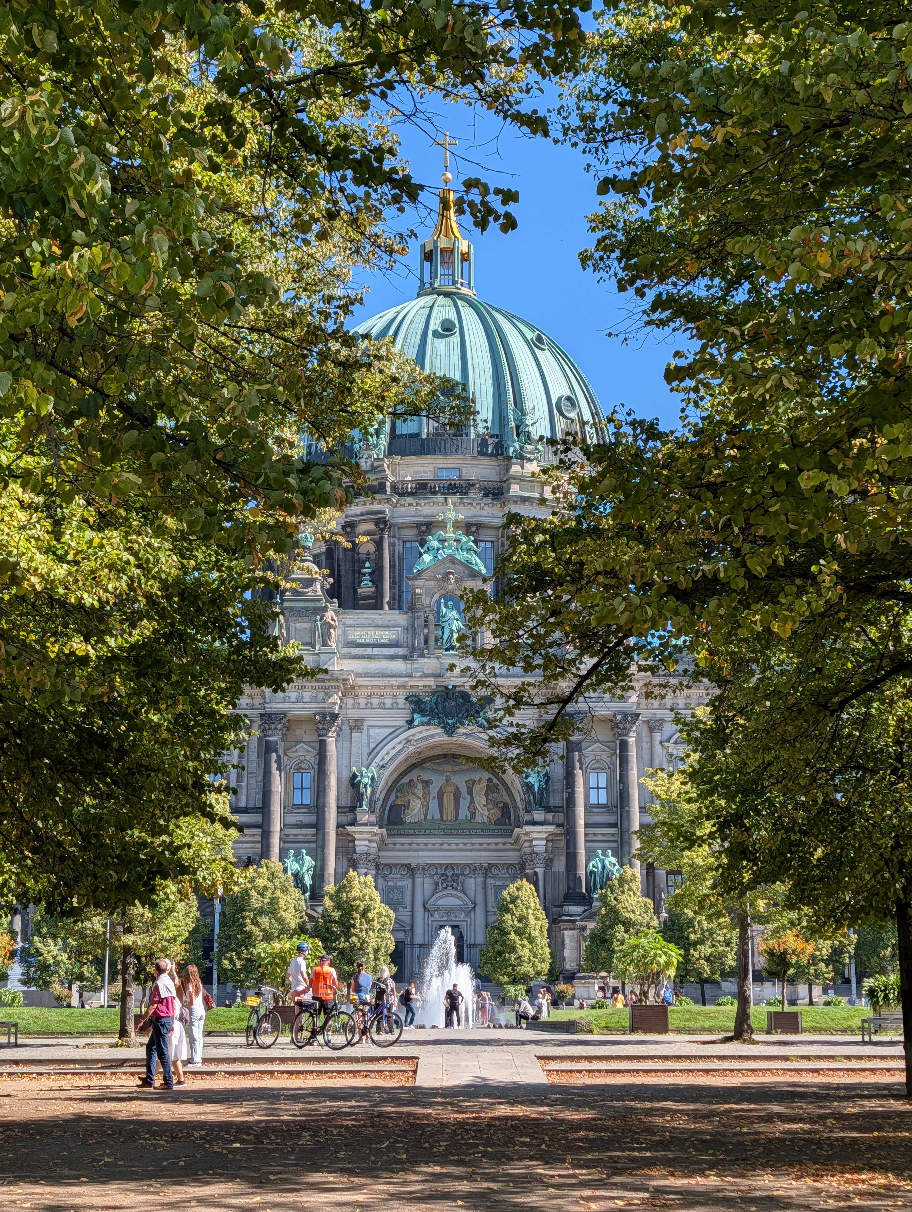 The Berliner Dom in Berlin scene through a gap between trees