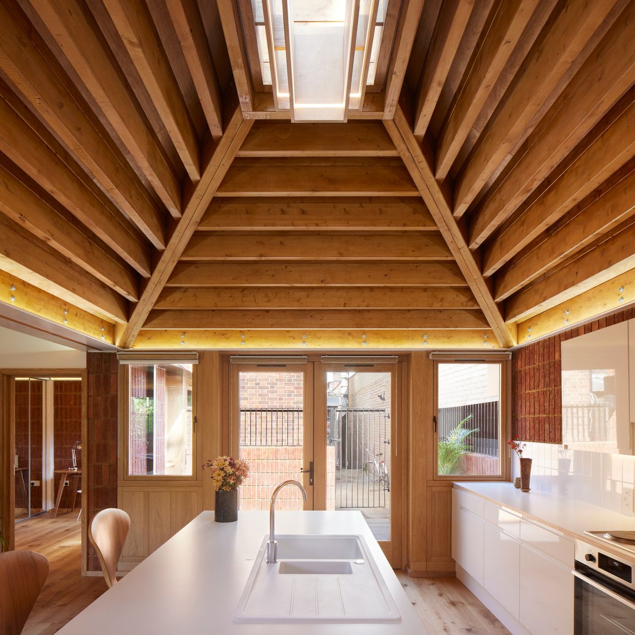 A kitchen in a single storey house with a vaulted ceiling and skylight