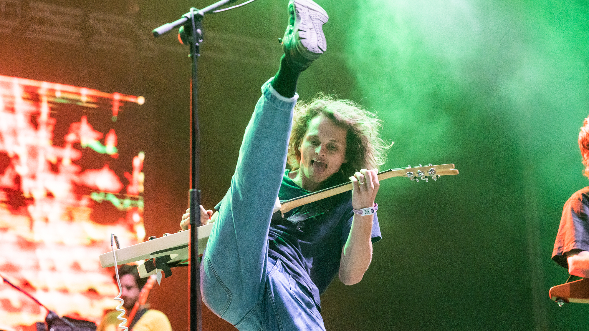 Guitarist and vocalist Stu Mackenzie of King Gizzard &amp; The Lizard Wizard performs live on stage kicking up his leg and sticking out his tongue during Primavera Sound 2022