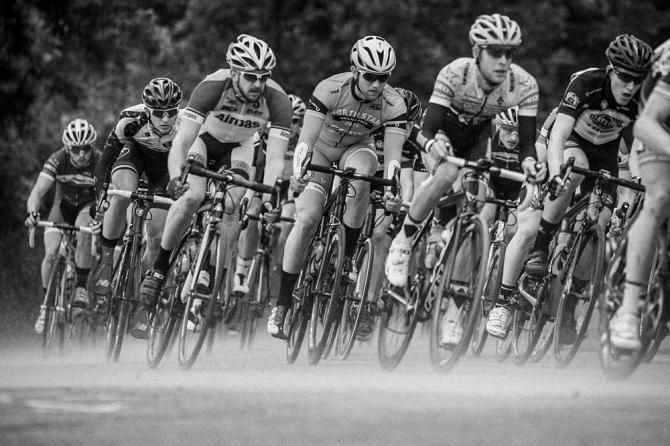 Riders kick up dust along the road before the rain sets in