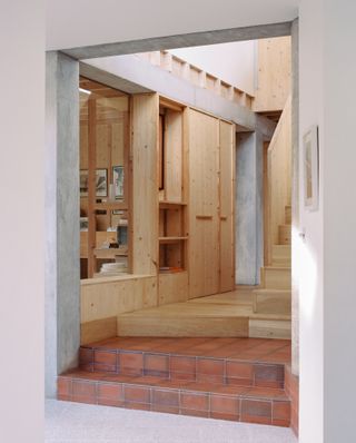 Six Columns House by 31/44 Architects entrance to wood stairs