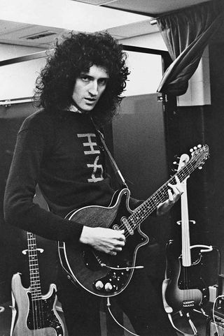 Brian May with a guitar in the studio