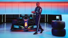 Lewis Hamilton posed next to his racing car, with INEOS Hand Sanitizer dispenser