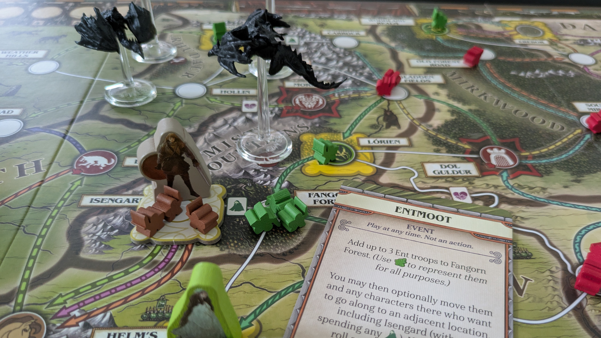A selection of tokens, meeple, cards, and pieces on the Fate of the Fellowship board