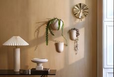 A set of white fluted wall vases in a living room