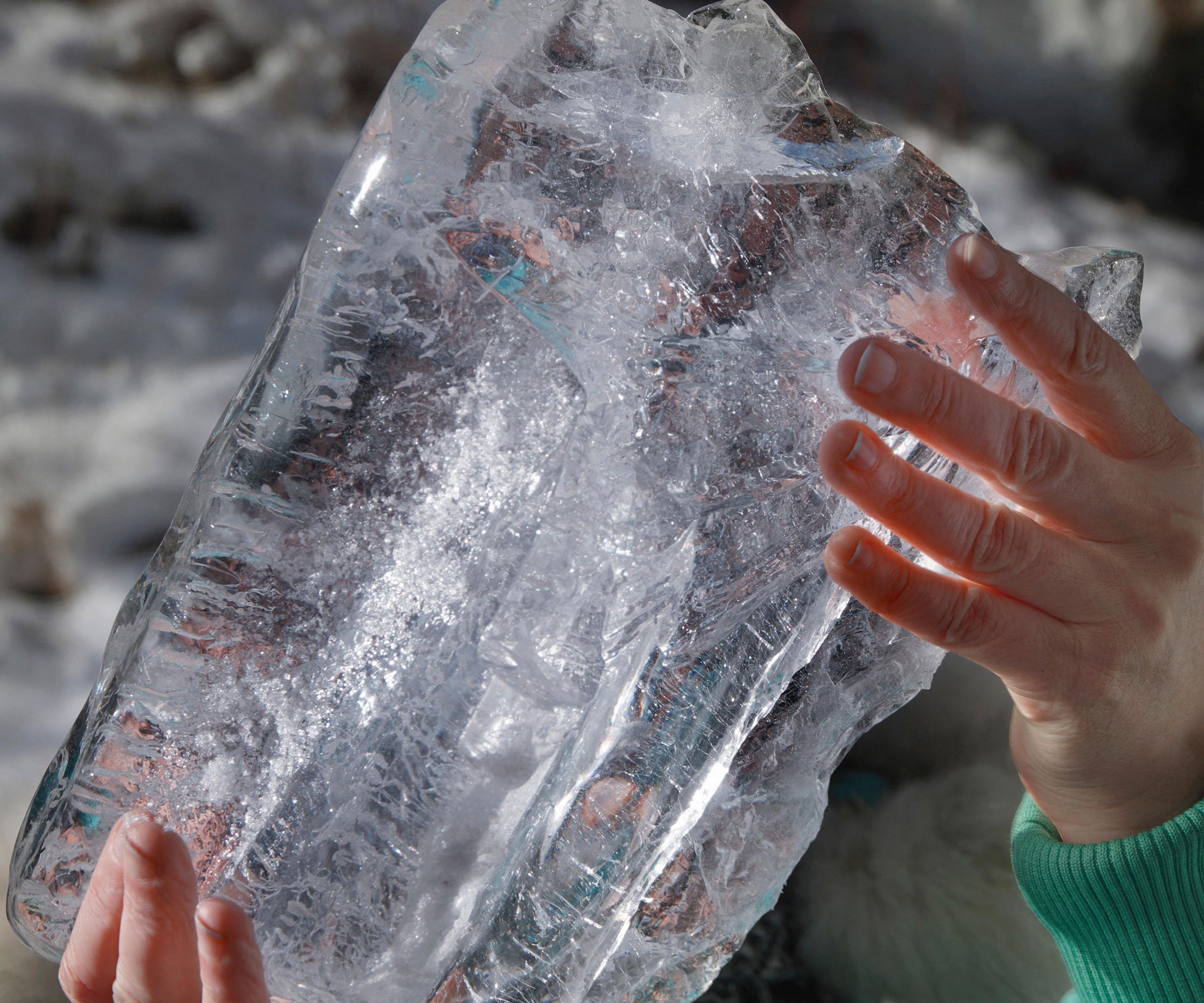 hands holding large block of ice