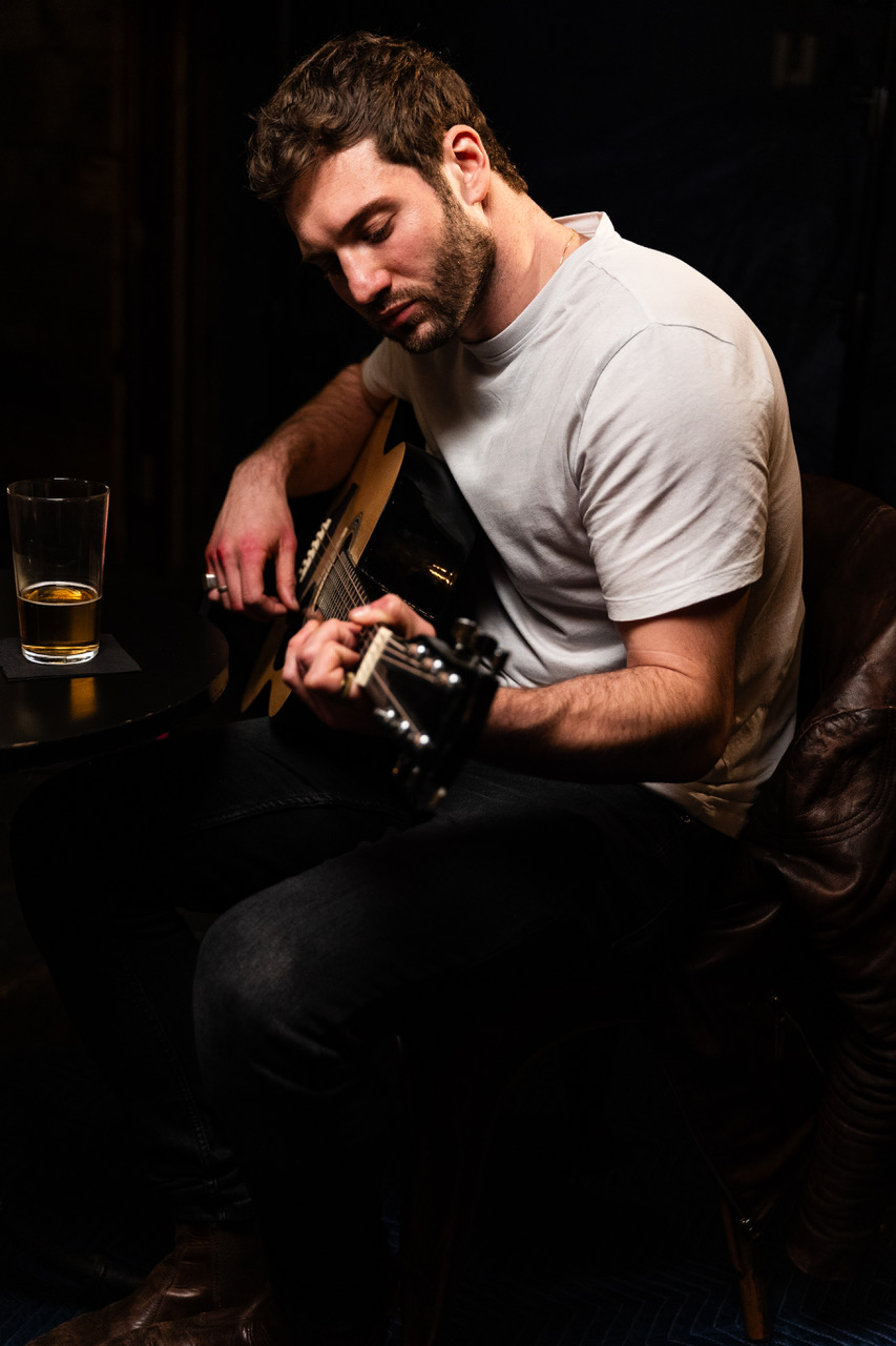 an image of alexander lincoln playing the guitar