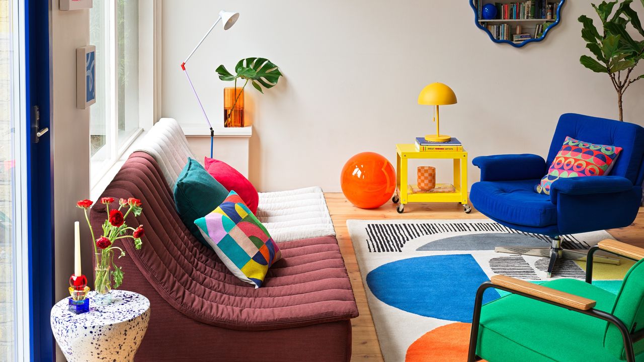 A colourful living room filled with pieces from Habitat&#039;s spring/summer 2025 collection including the Caliban XL globe light in orange placed on the floor