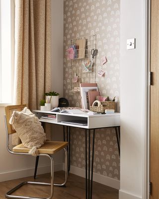 boho style office with printed drapes, white desk, rattan chair, desk accessories, wallpaper