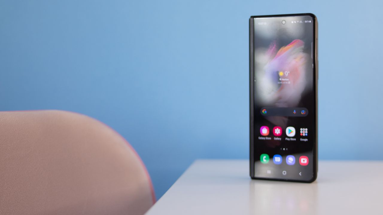 A photograph of the Samsung Galaxy Z Fold 3 folded over and stood on a table
