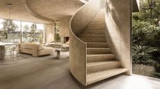 A curved staircase in a minimalist beige home with silver decor accents