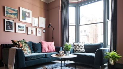 Living room with dark sofas and painted window frames