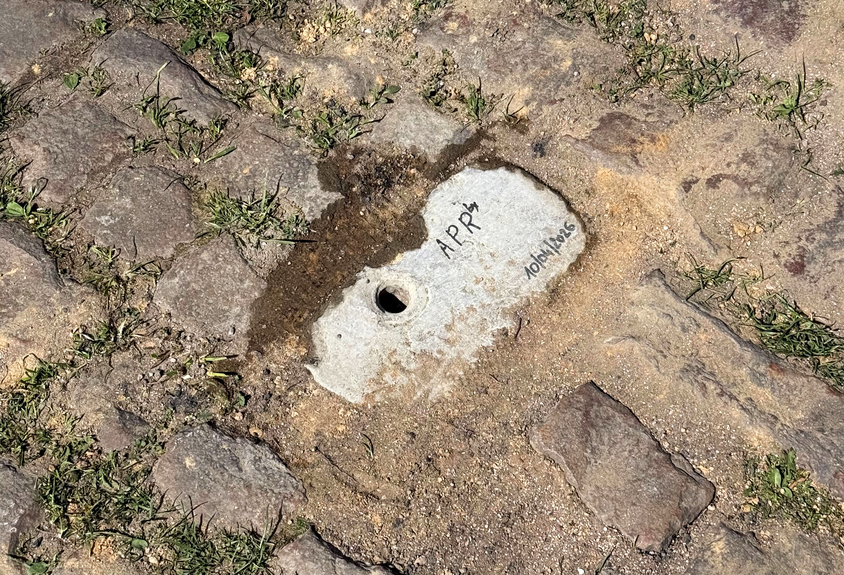 A makeshift cover on a missing cobble gap on the Arenberg sector of Paris-Roubaix