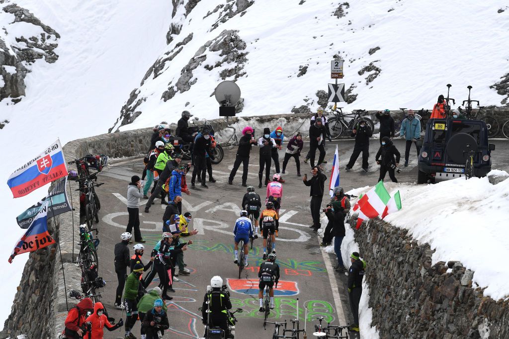 LAGHI DI CANCANO ITALY OCTOBER 22 Joao Almeida of Portugal and Team Deceuninck QuickStep Pink Leader Jersey Fausto Masnada of Italy and Team Deceuninck QuickStep Hermann Pernsteiner of Austria and Team Bahrain Mclaren Rafal Majka of Poland and Team Bora Hansgrohe Passo dello Stelvio Stilfserjoch 2758m Snow Fans Public during the 103rd Giro dItalia 2020 Stage 18 a 207km stage from Pinzolo to Laghi di Cancano Parco Nazionale dello Stelvio 1945m girodiitalia Giro on October 22 2020 in Laghi di Cancano Italy Photo by Tim de WaeleGetty Images