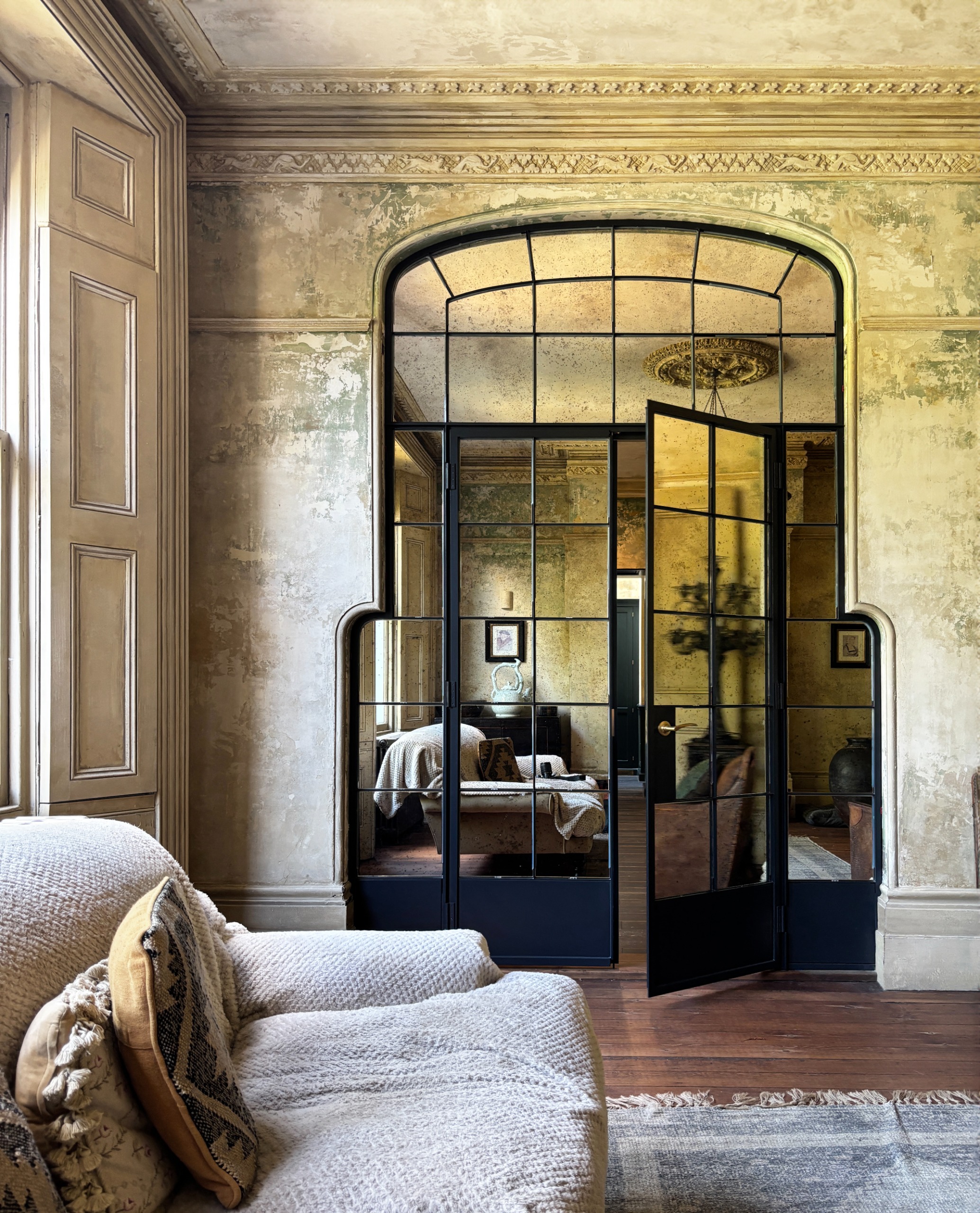 period living room with crown molding and mirrored crittall doors