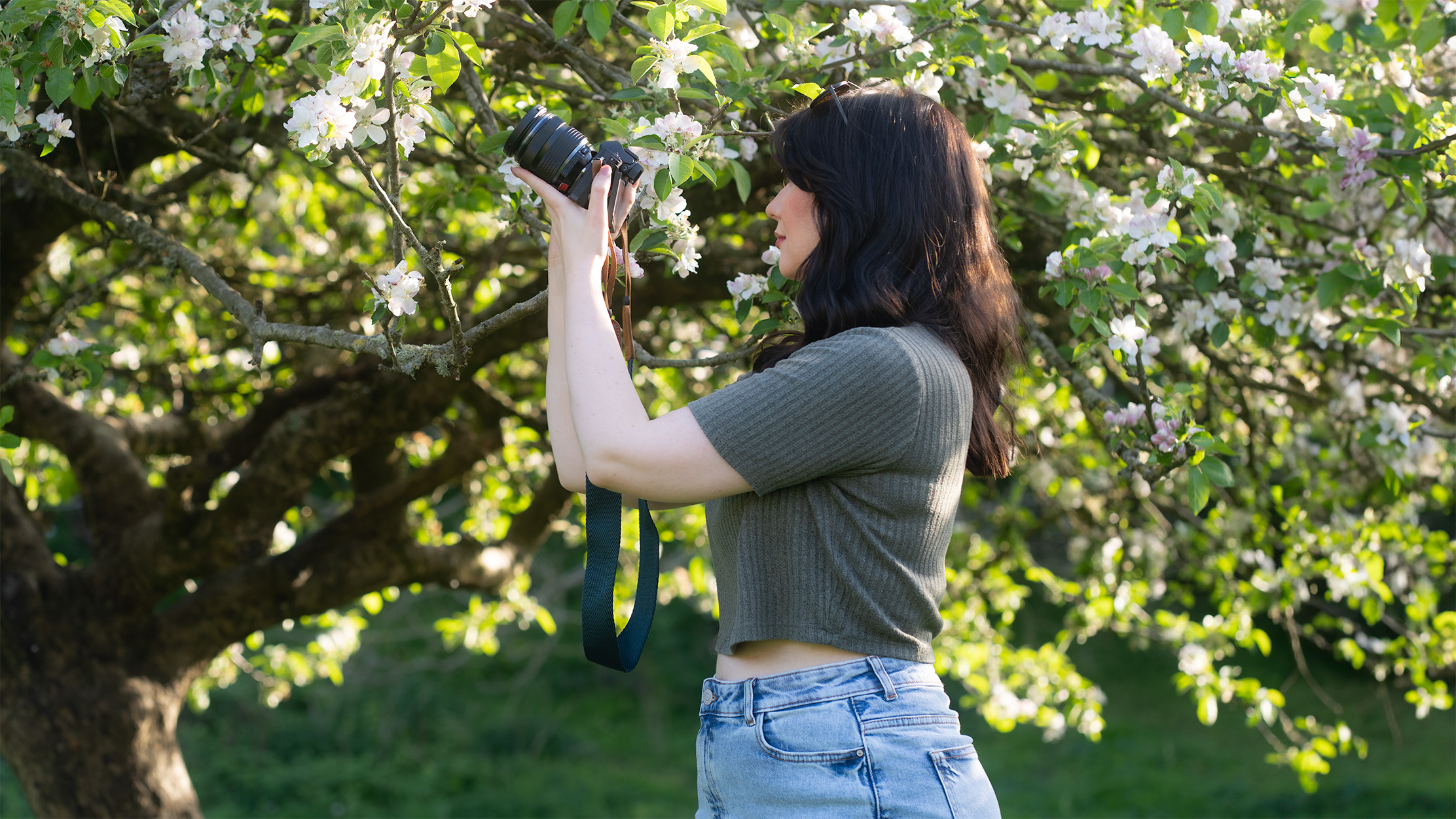 woman holding the Olympus OM-D E-M10 Mark IV