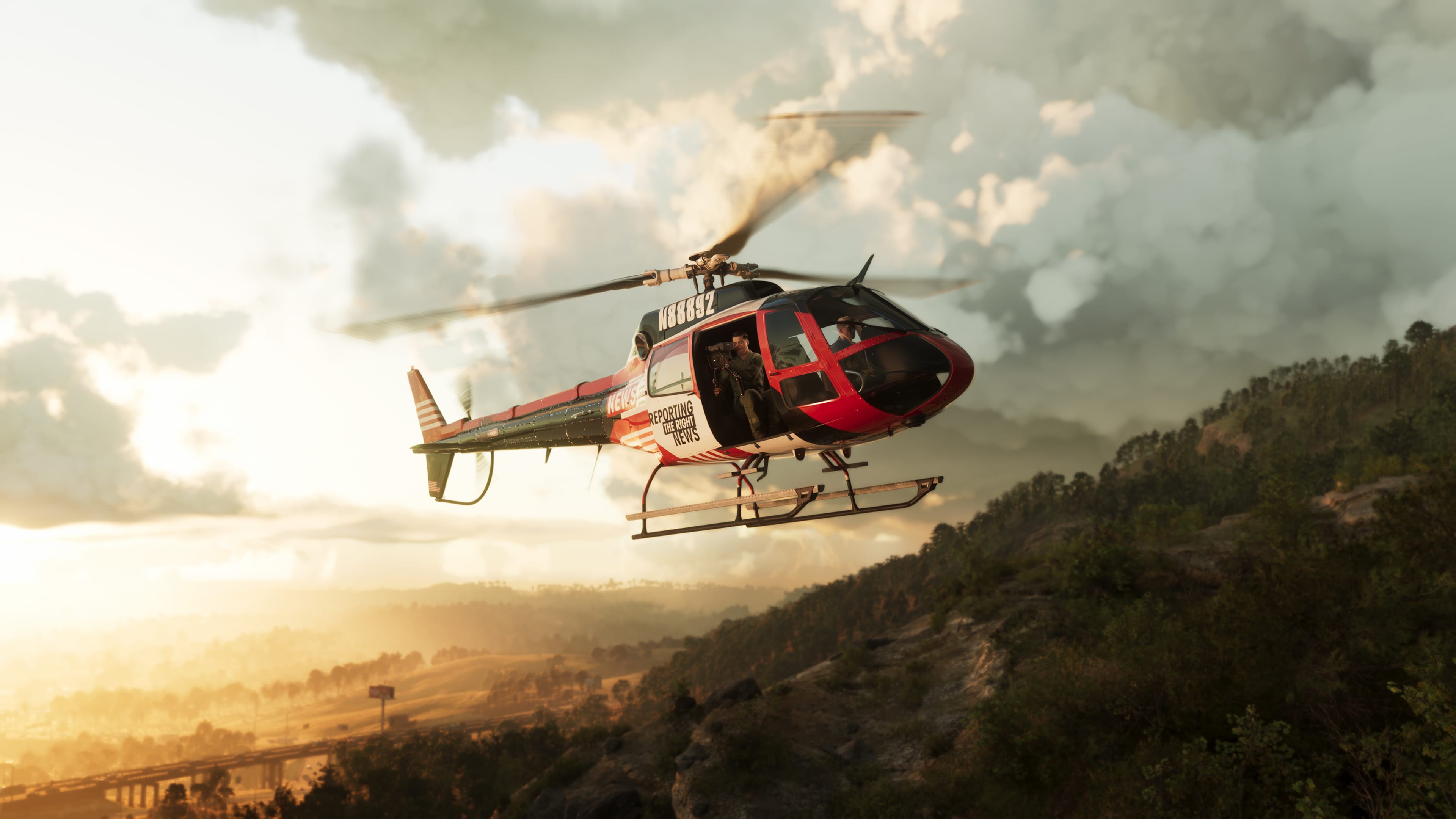 A news helicopter flies past a misty, forested hillside during a hazy sunset.