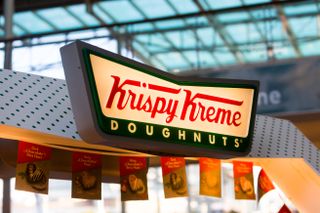 The Krispy Kreme logo above the doorway of one of its high street shops.