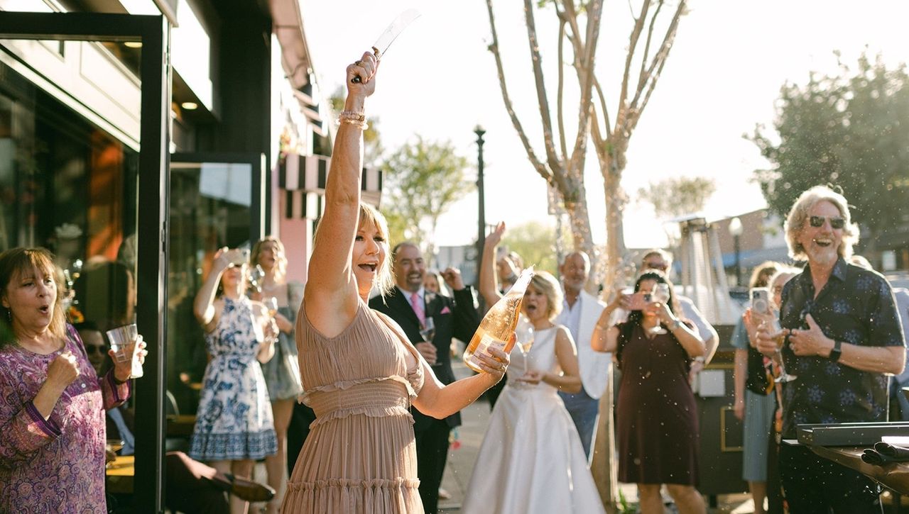 Erin Riley celebrates outside of her champagne bar