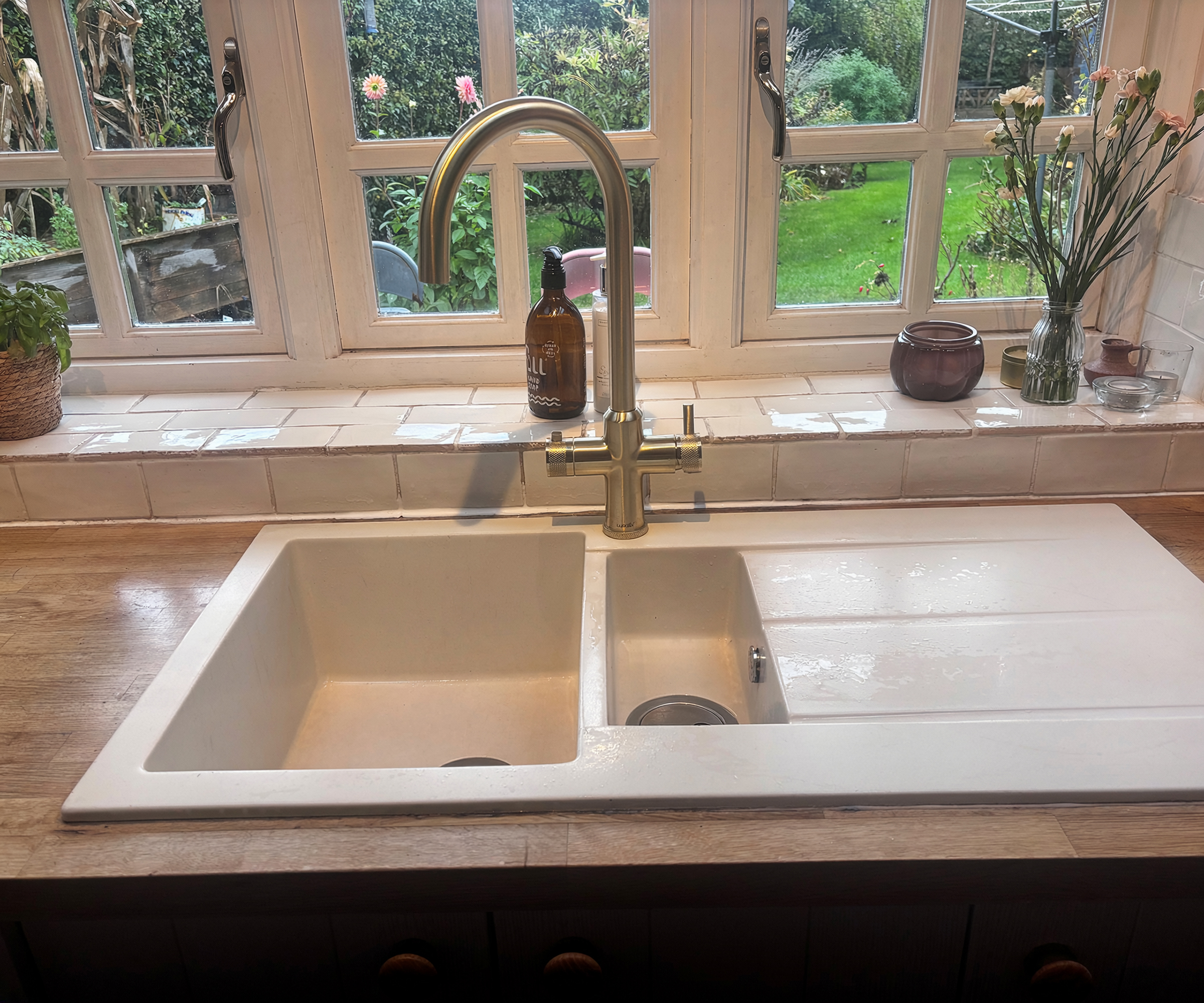 brushed brass boiling water tap with white composite sink