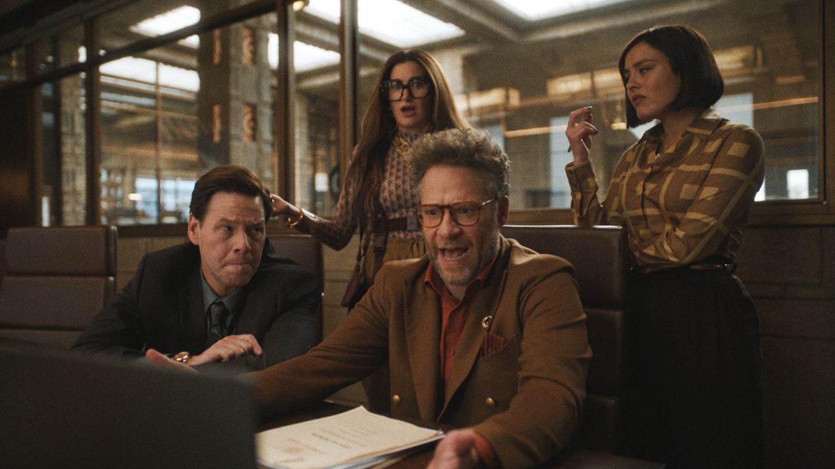 Ike Barinholtz, Kathryn Hahn and Chase Sui Wonders around Seth Rogen at a desk in The Studio