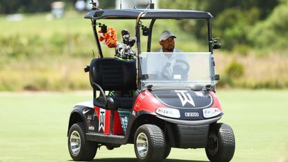 Tiger Woods driving a golf cart