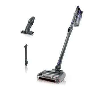 A gray and purple cordless vacuum with two black attachments to the left